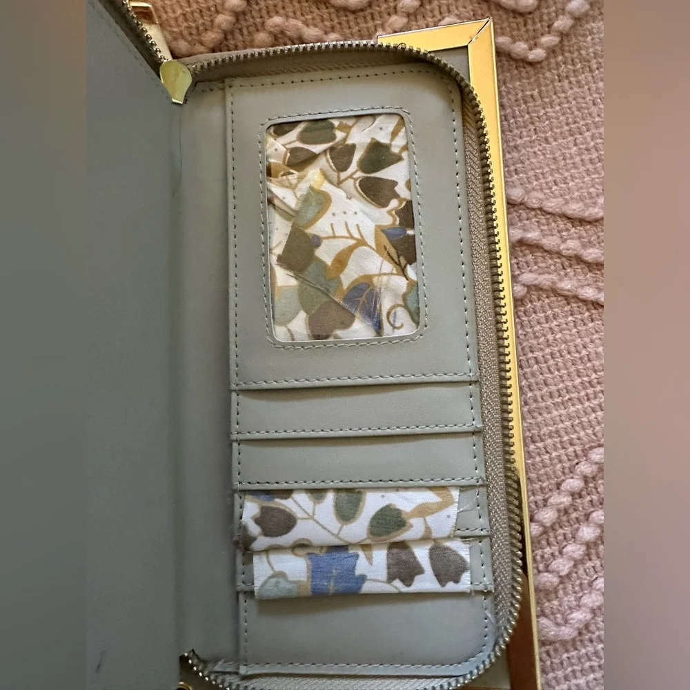 Women’s wristlet with gold accents and‎ wrist strap